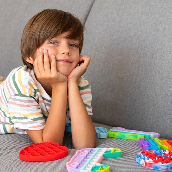 child playing with fidget toys happy learning